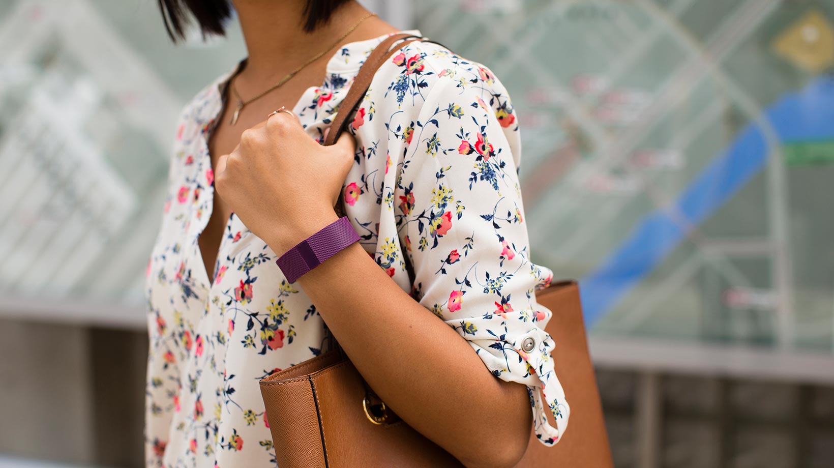 Person wearing a purple Fitbit band